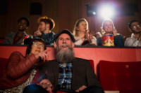 seniorzy oraz widownia w kinie na krzeslach