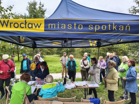 Grupa osób przy namiocie w ramach Rajdu terenowego grupy senioralnej o-CAL-eni.